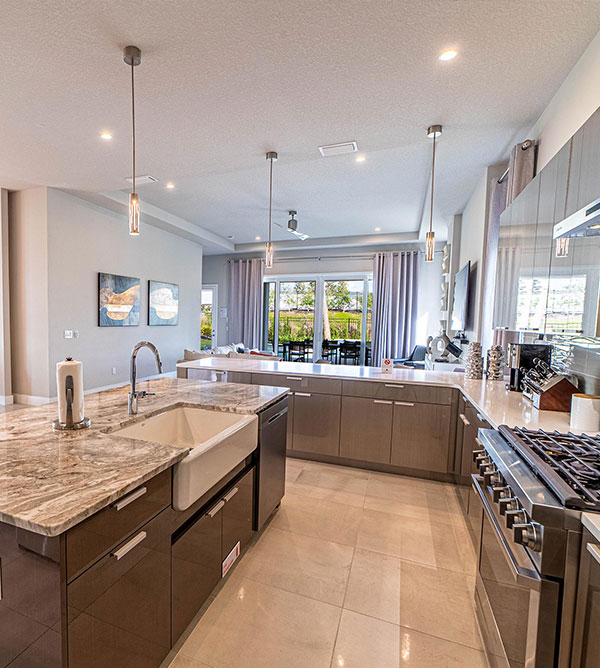 Furnished kitchen with island sink inside a Bear’s Den Resort Orlando vacation home.