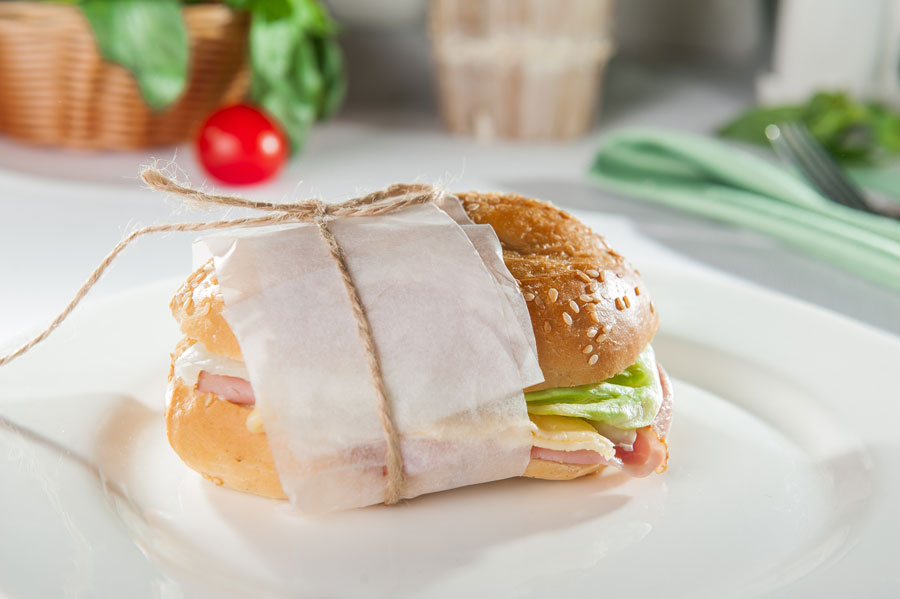 Carved ham sandwich on a sesame seed bun.
