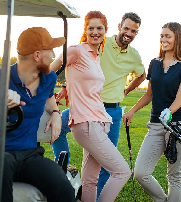 Group of 2 couples on the golf course with golf cart.