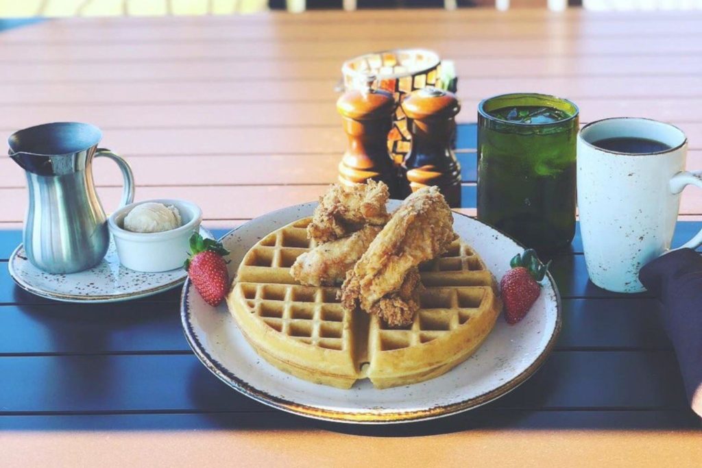 Breakfast plate of chicken and waffles.