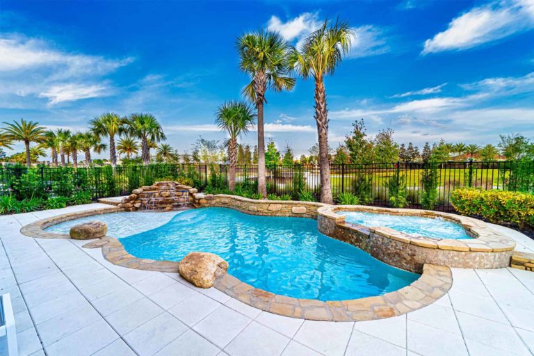 Backyard pool with hot tub and waterfall at a Bear’s Den Resort Orlando vacation home.