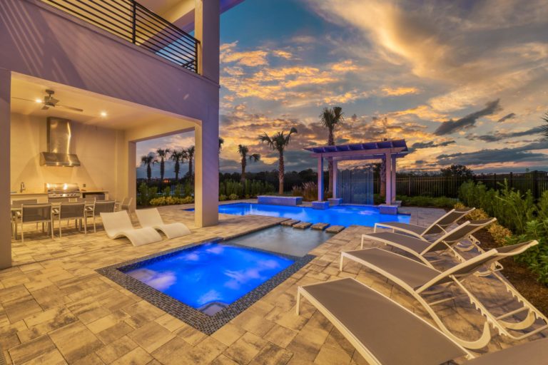 Private pool and hot tub at an 8-bedroom Bear’s Den home at sunset.