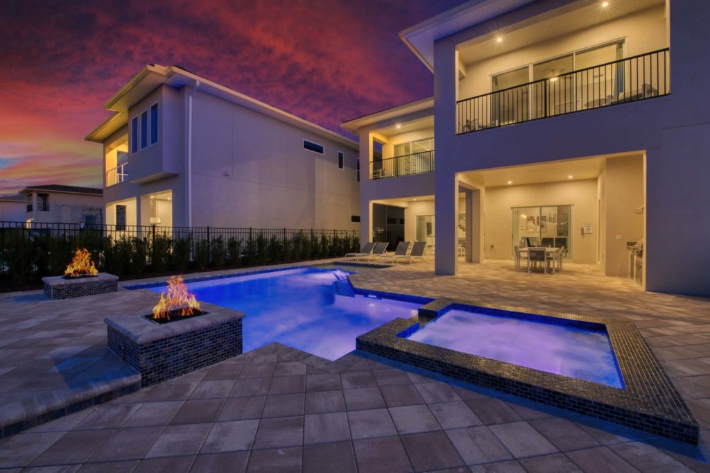 Lit private pool, fire pits, and heated spa at an elegant 8-bedroom Bear’s Den Resort Orlando residence.