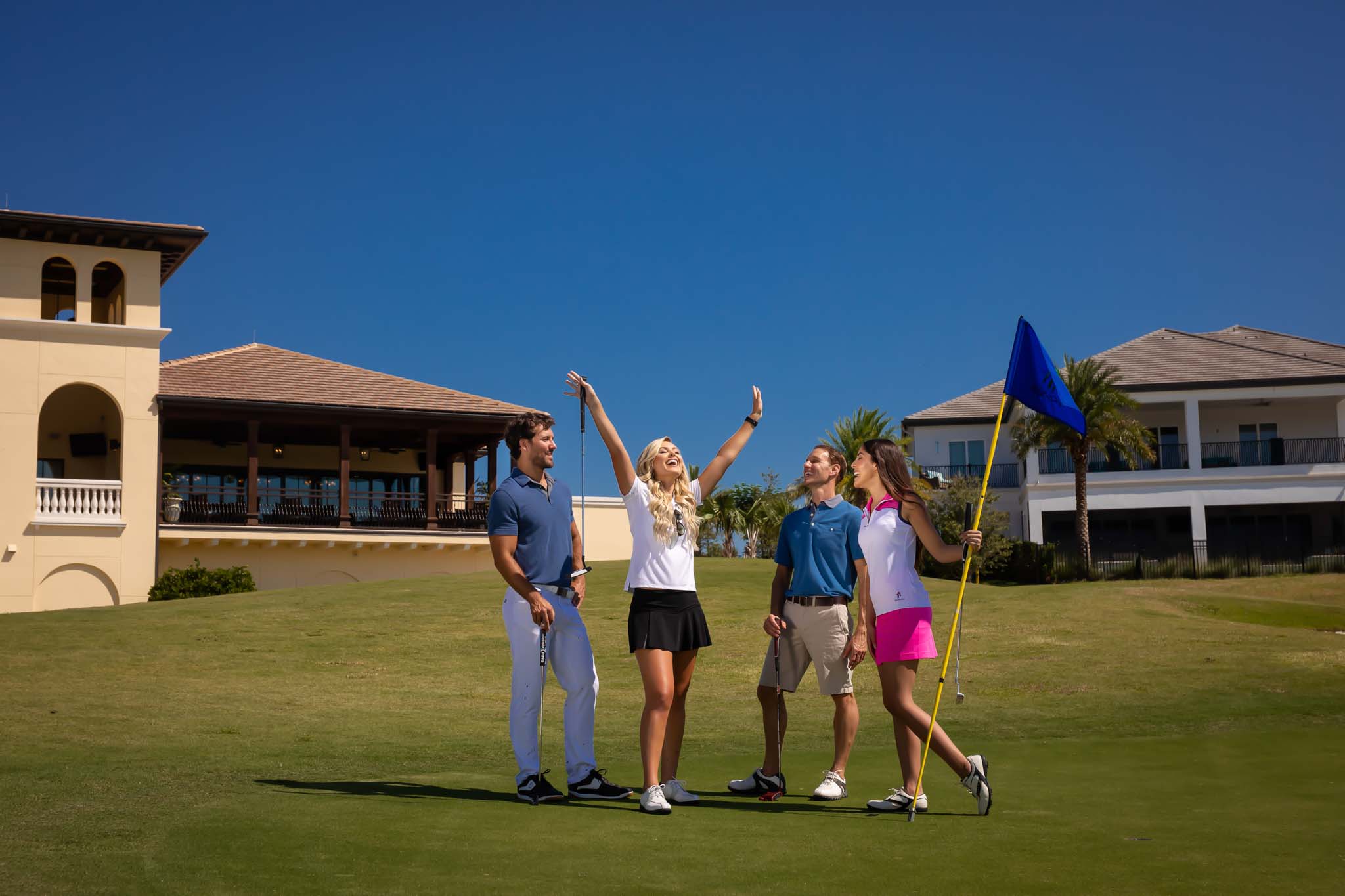 Mom cheering on the golf course surrounded by her partner and friends at The Bear’s Den Resort Orlando.