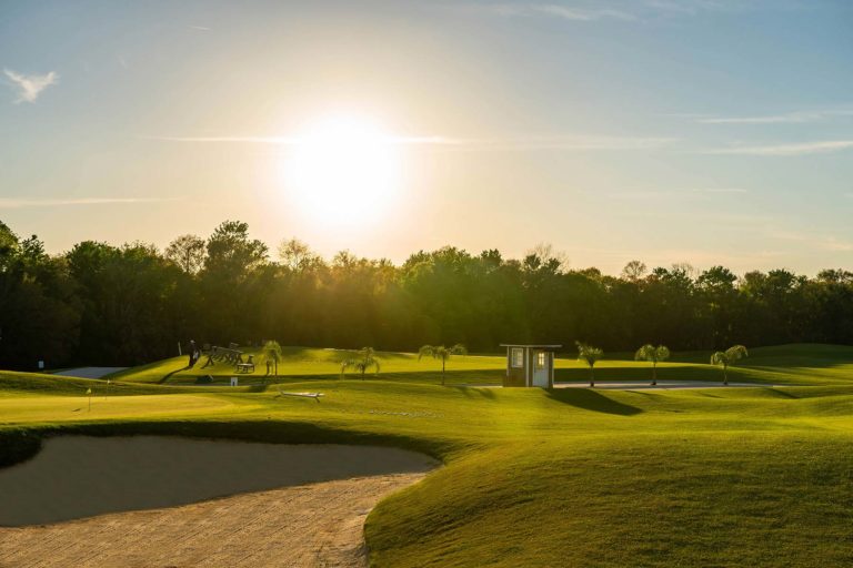 Bear's Den Resort Orlando Golf Course Driving Range Lined With Sand Traps At Sunset.