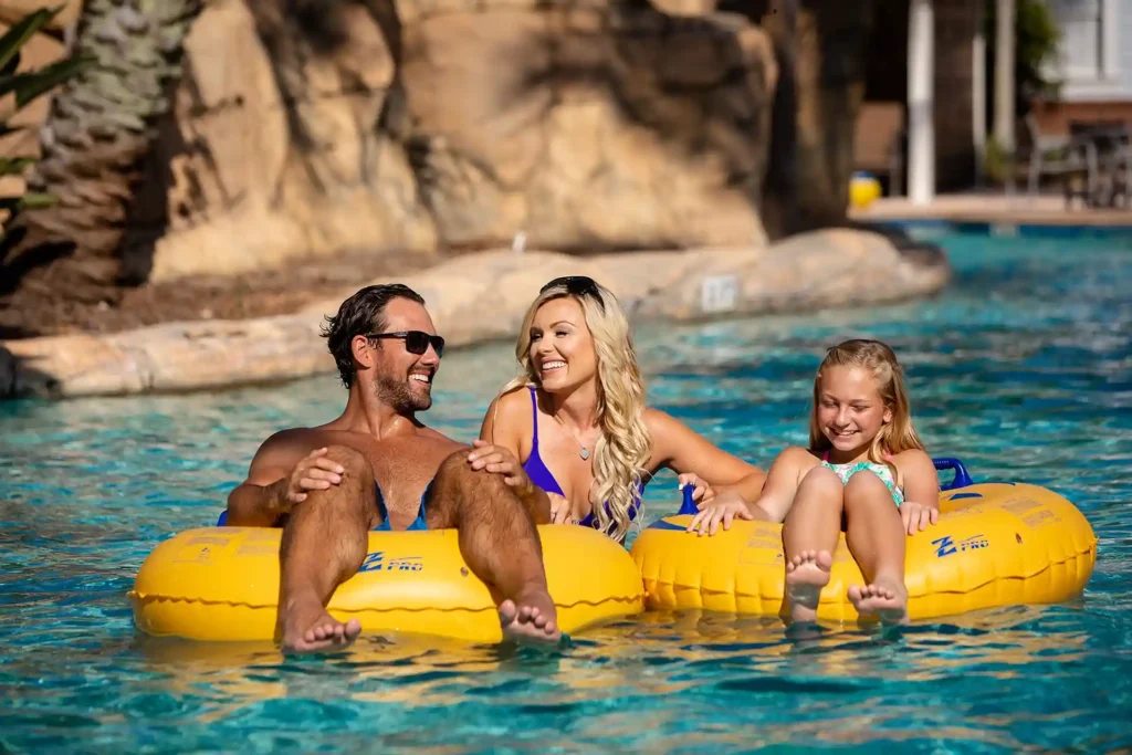 Happy family riding in tube floats on lazy river ride at the Bear’s Den water park