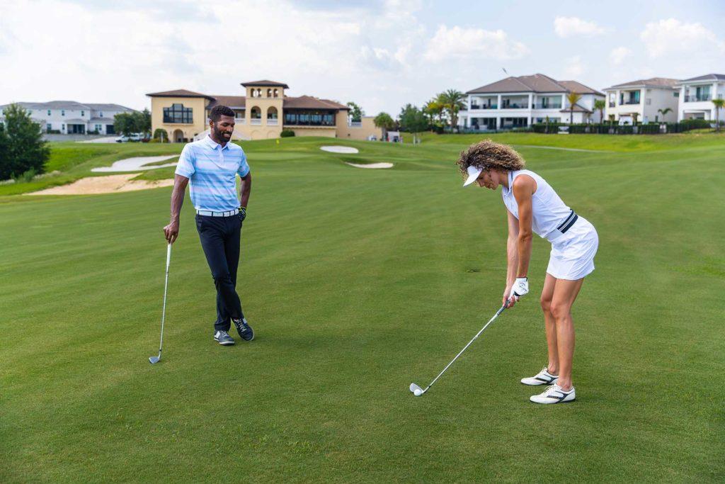 Couple playing a round of golf at the Bear's Den Resort Orlando