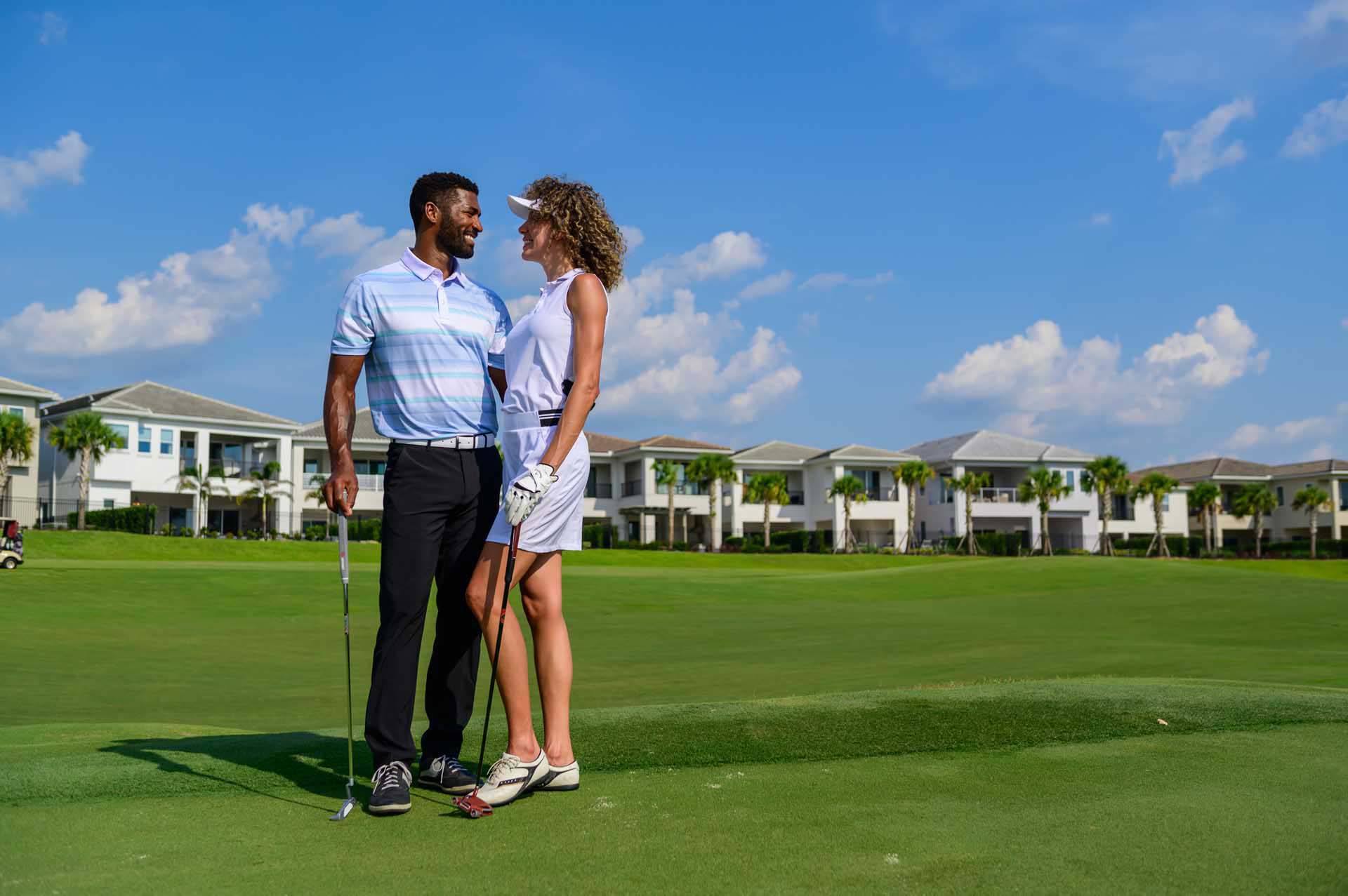 Happy golfing couple standing on a golf course at the Bear's Den Resort Orlando