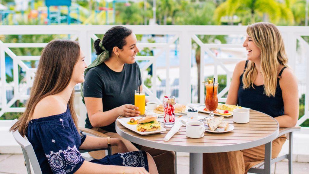 Group of friends enjoying brunch outside at the Encore Resort clubhouse