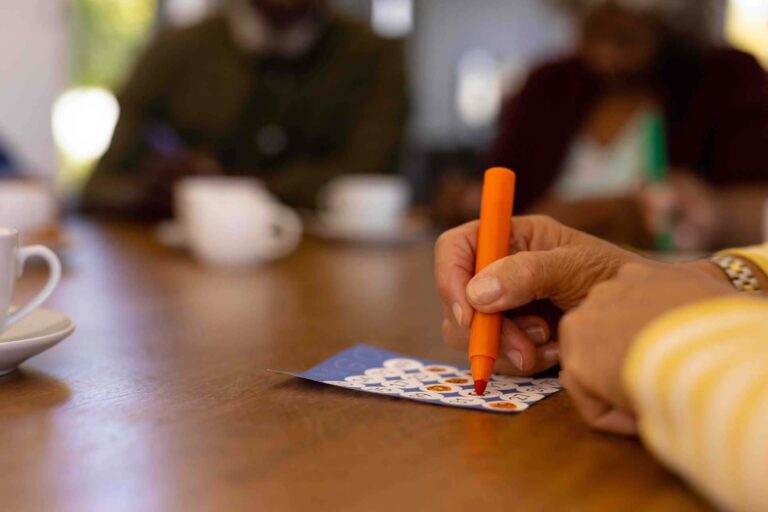 Older woman marking a bingo card