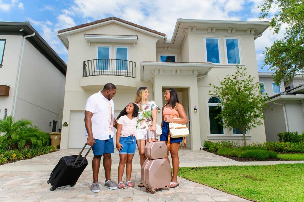 Family arriving at their Bear's Den Resort home with luggage