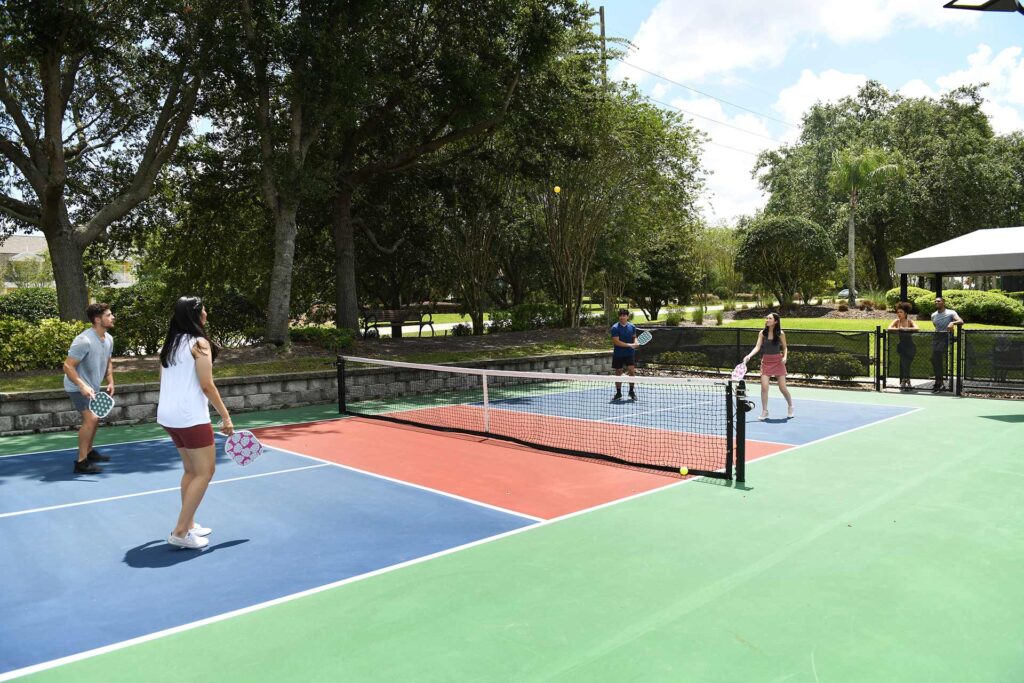 Group of friends playing pickleball at Reunion Resort