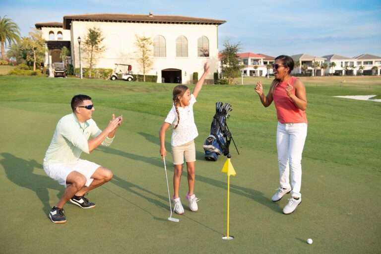 Family having fun while playing a round of golf at the Bear's Den Resort