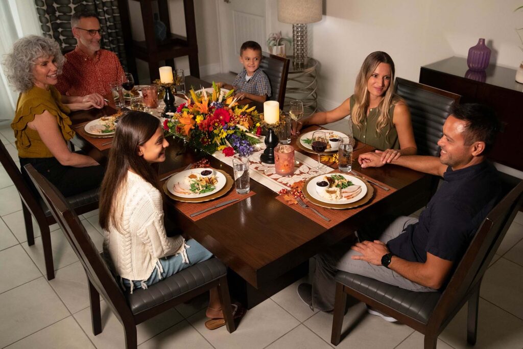 Extended family having Thanksgiving dinner in their Rentyl Resort home
