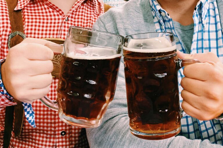 Men toasting pints of beer for Oktoberfest