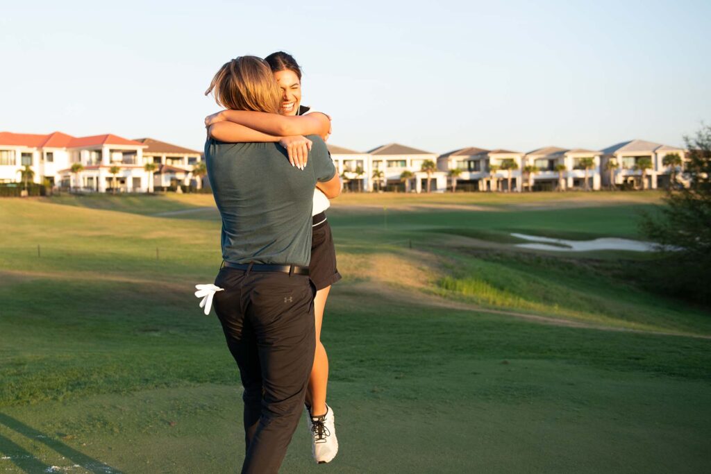 Happy couple hugging on the golf course at the Bear's Den Resort Orlando