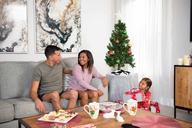 Family celebrating Christmas in their Bear's Den Resort home living room