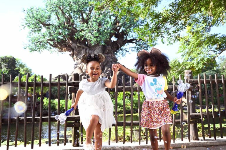 Sisters having fun in front of Disney's Animal Kingdom Tree of Life