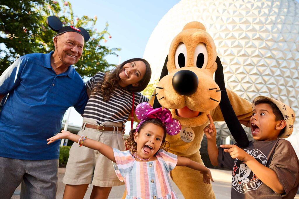 Happy family taking a photo with Pluto at EPCOT