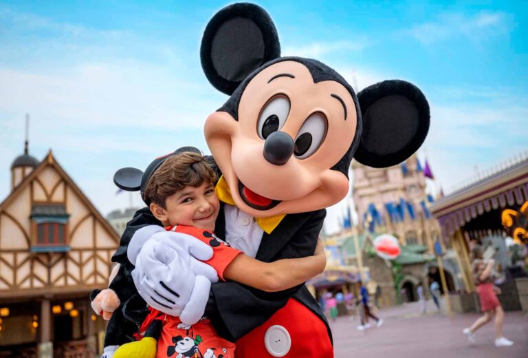 Boy hugging Mickey mouse at the Magic Kingdom
