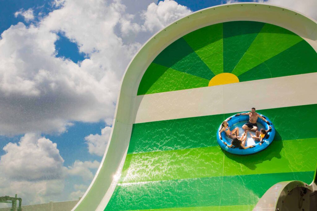 Family in a raft on the Profile Plunge water slide at Island H2O Water Park