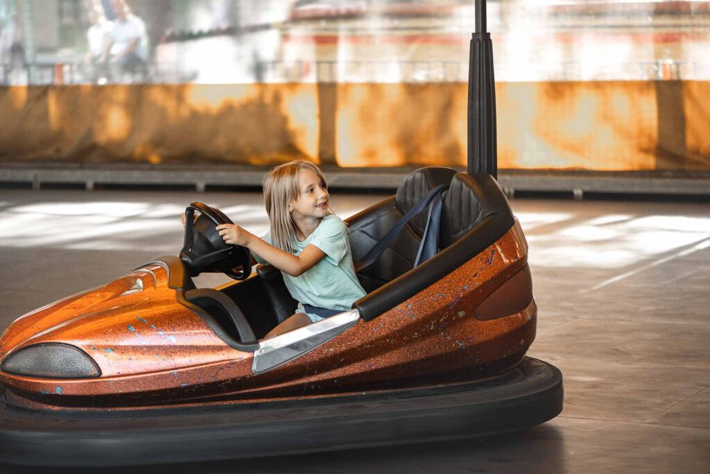 Young girl driving a bumper car