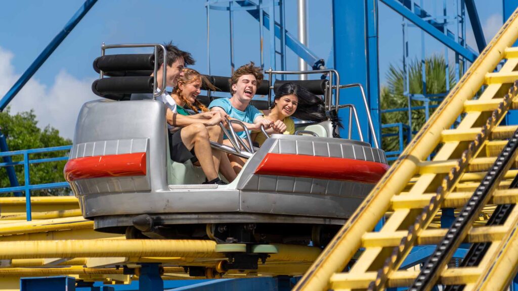 Group of friends riding on the Galaxy Spin roller coaster in Fun Spot America in Kissimmee, Florida