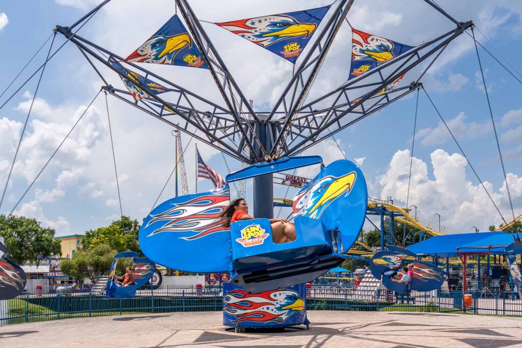 People enjoying the Screaming Eagles ride in Fun Spot America in Kissimmee, Florida