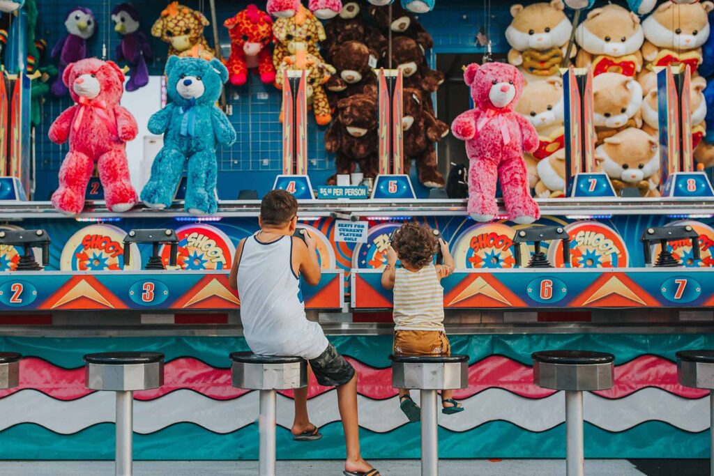 Father and son playing a water gun midway game